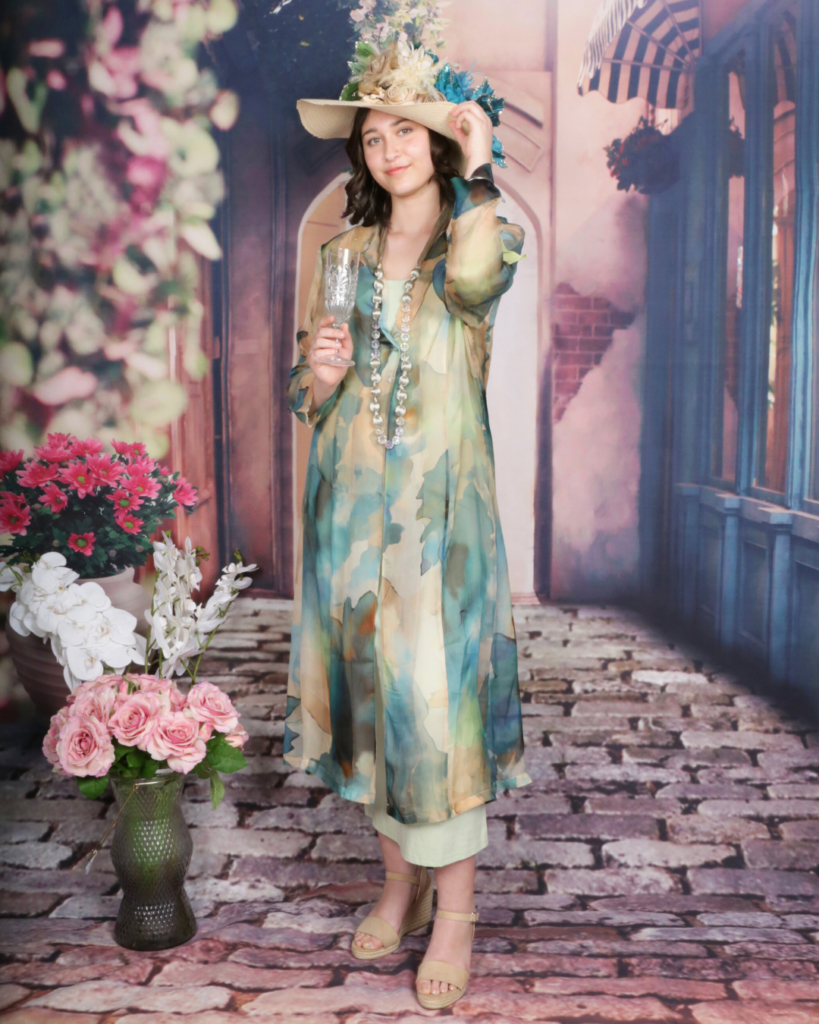 Silk dress with teal floral prints on a camel background, layered over a sage green slip, perfect for race day outfits for women.